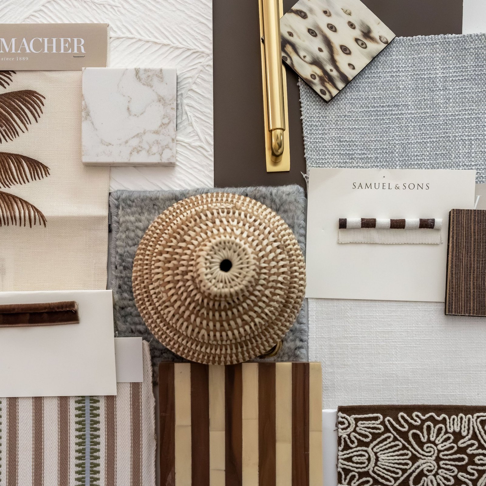 Flat lay of fabric, stone, wood, and trim samples in warm neutrals