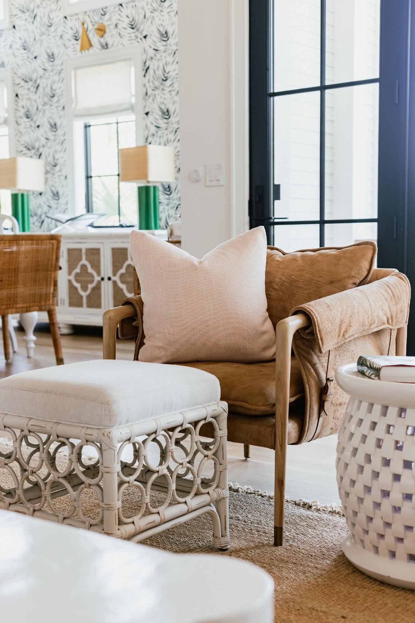 Suede lounge chair with rattan ottoman and woven side table