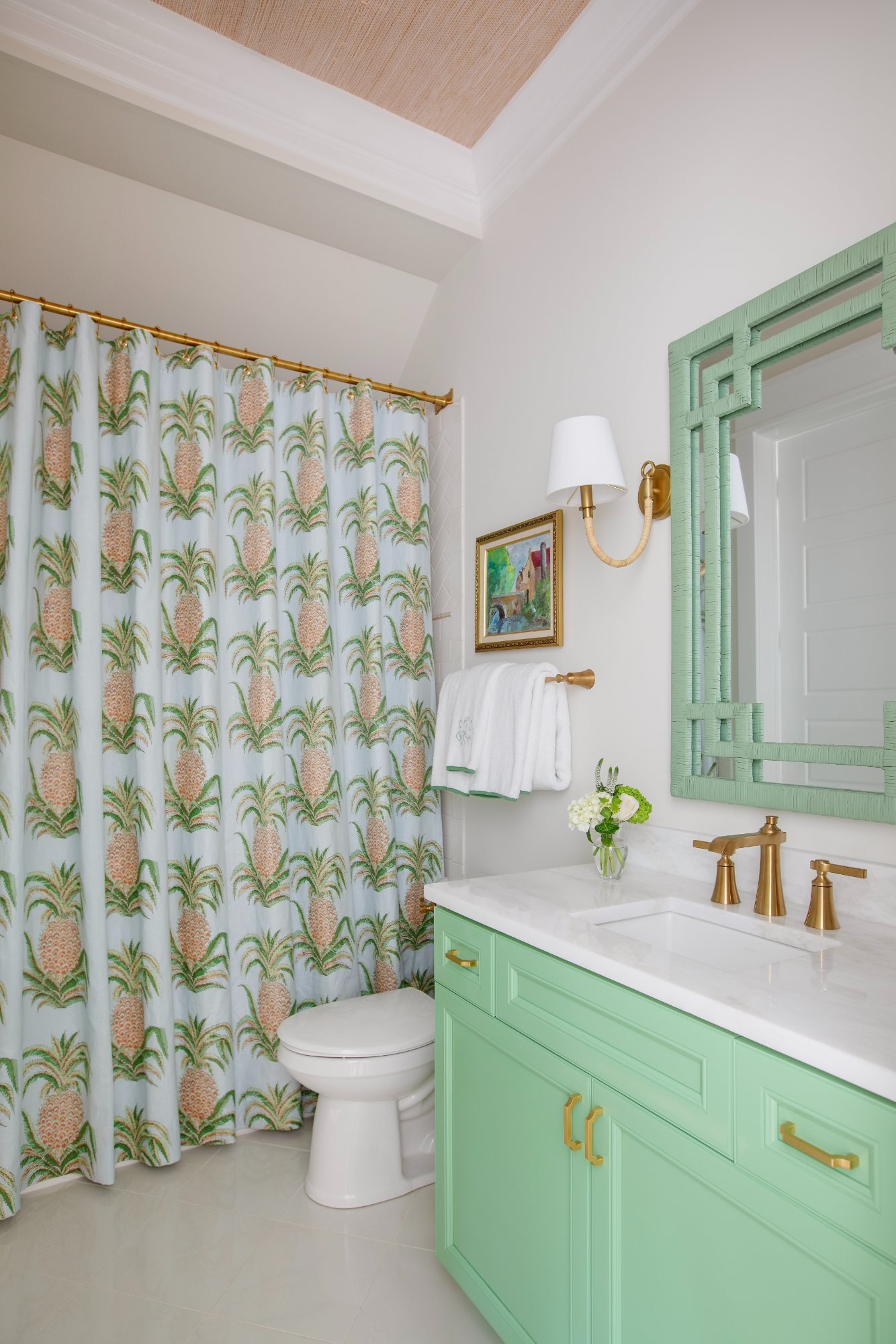 Guest bath with pineapple shower curtain, mint vanity, and grasscloth ceiling