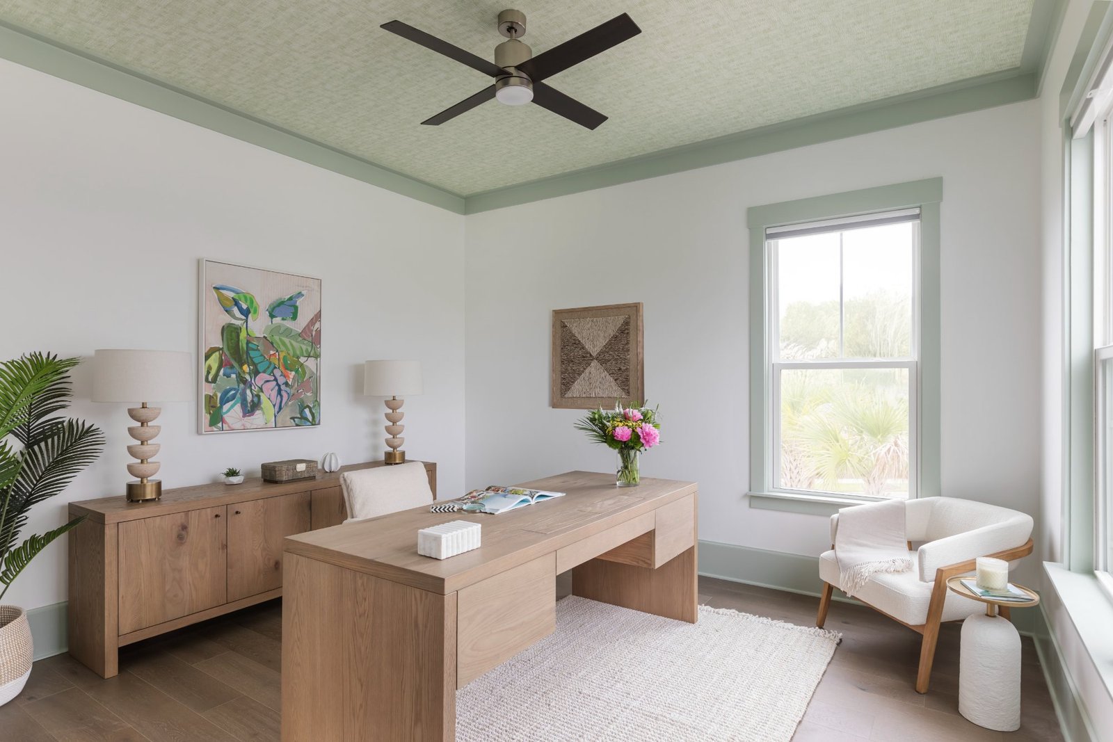 Study with sea-glass grasscloth ceiling, white oak desk, and boucle chair