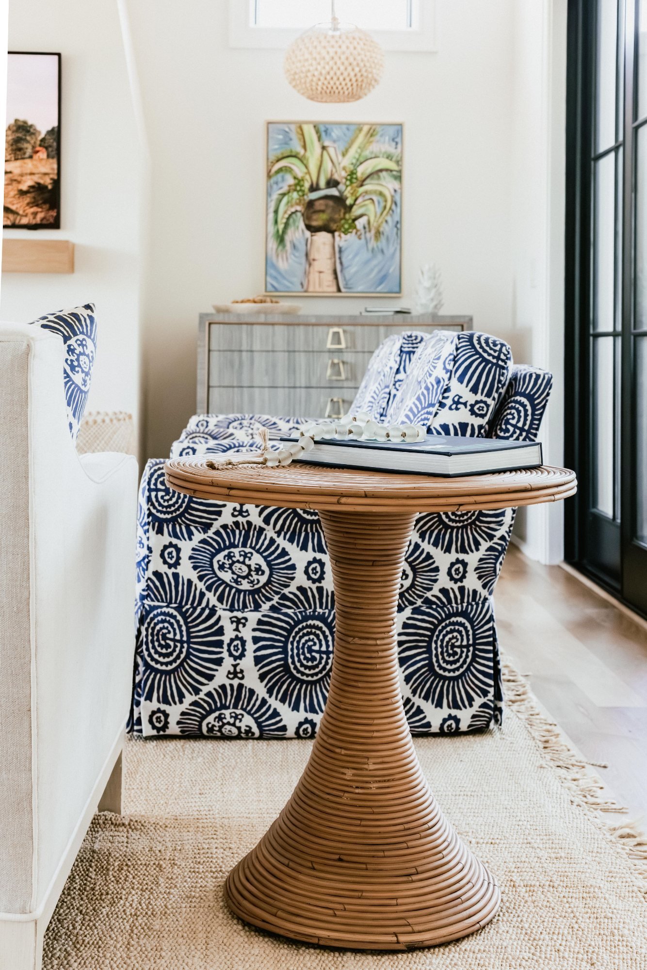 Blue-and-white block-print chair with rattan pedestal table on jute
