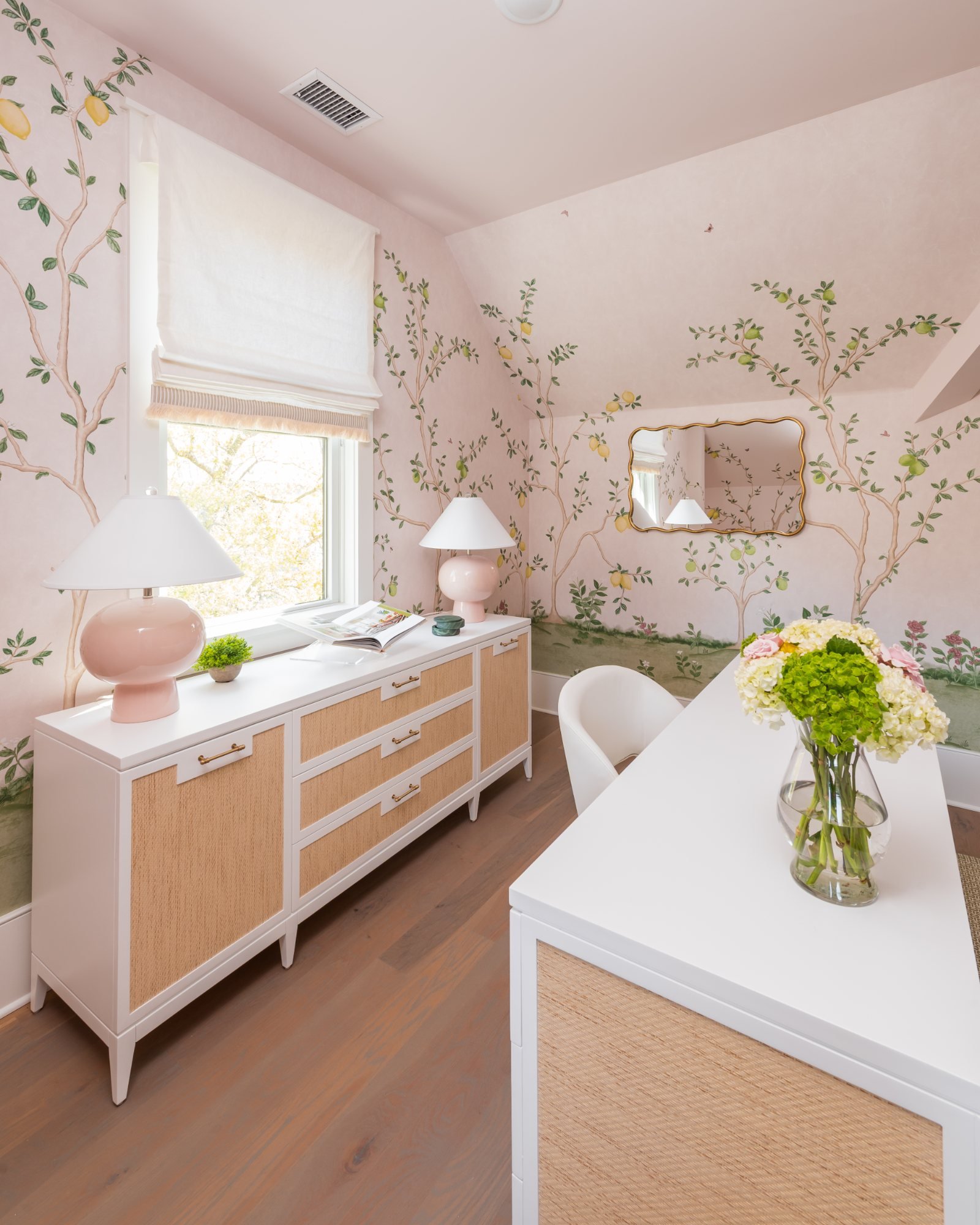 Blush lamp on the credenza beside the window