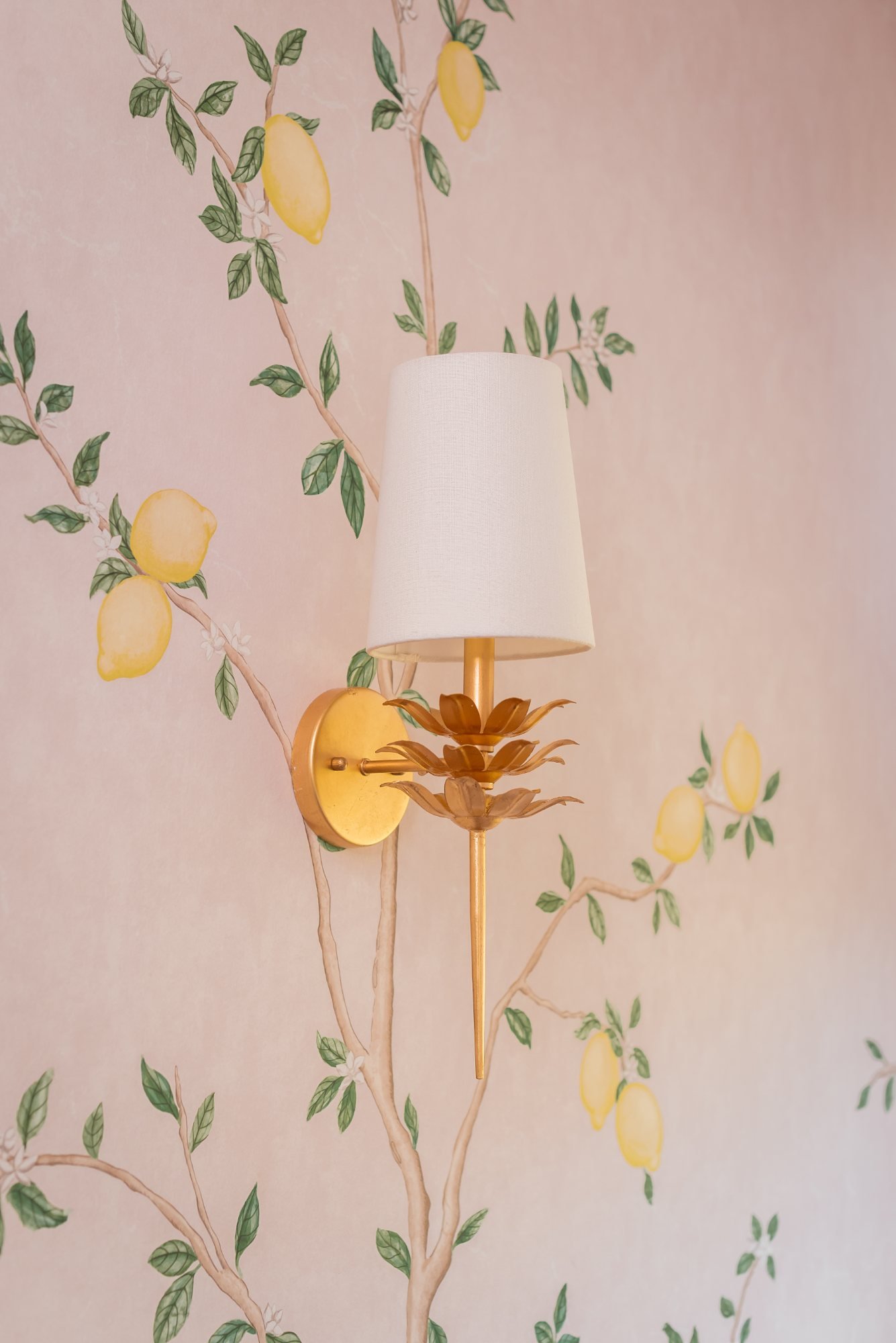 Gilt lotus sconce against the hand-painted lemon branches