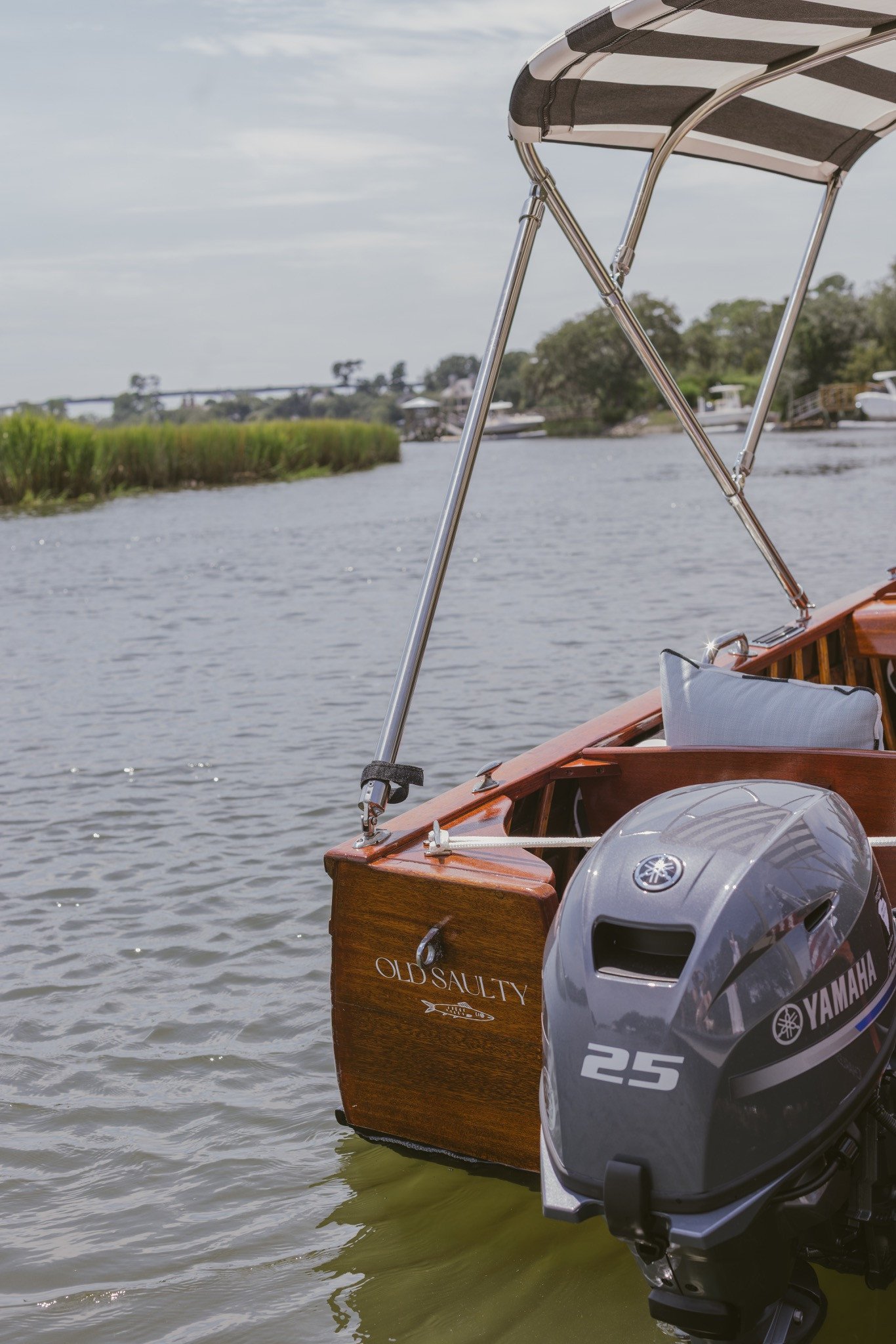 Old Saulty lettered on the mahogany transom beside the outboard
