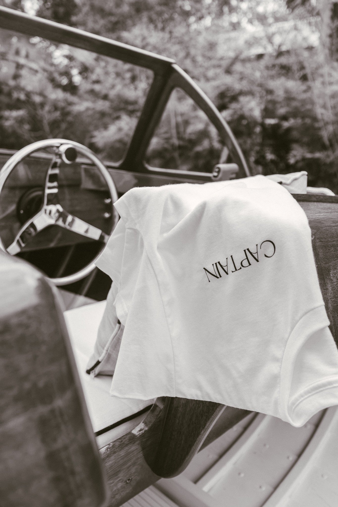 A white Captain shirt draped over the windshield beside the wheel