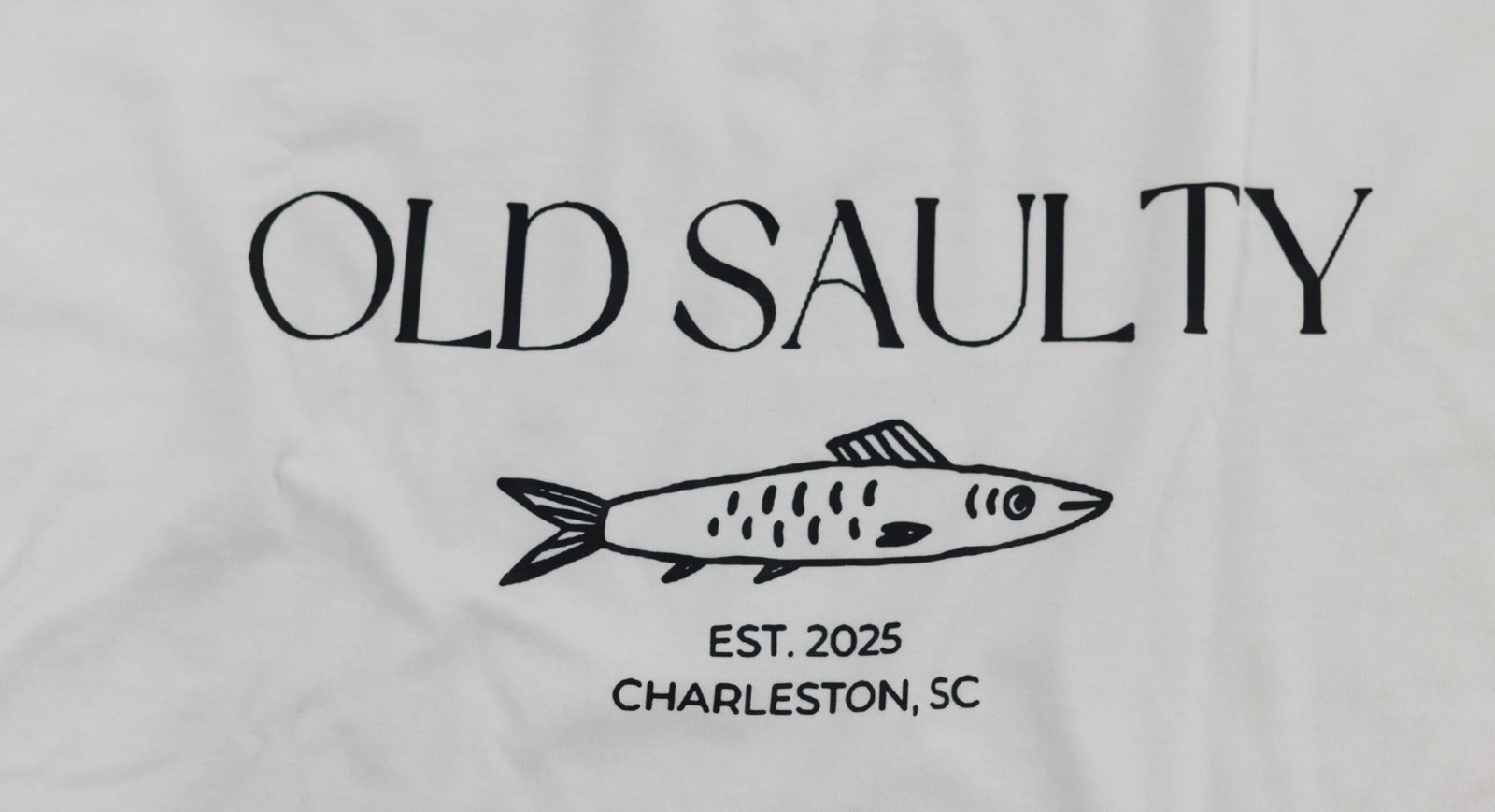 Old Saulty shirt graphic reading Est. 2025, Charleston, SC with a hand-drawn fish