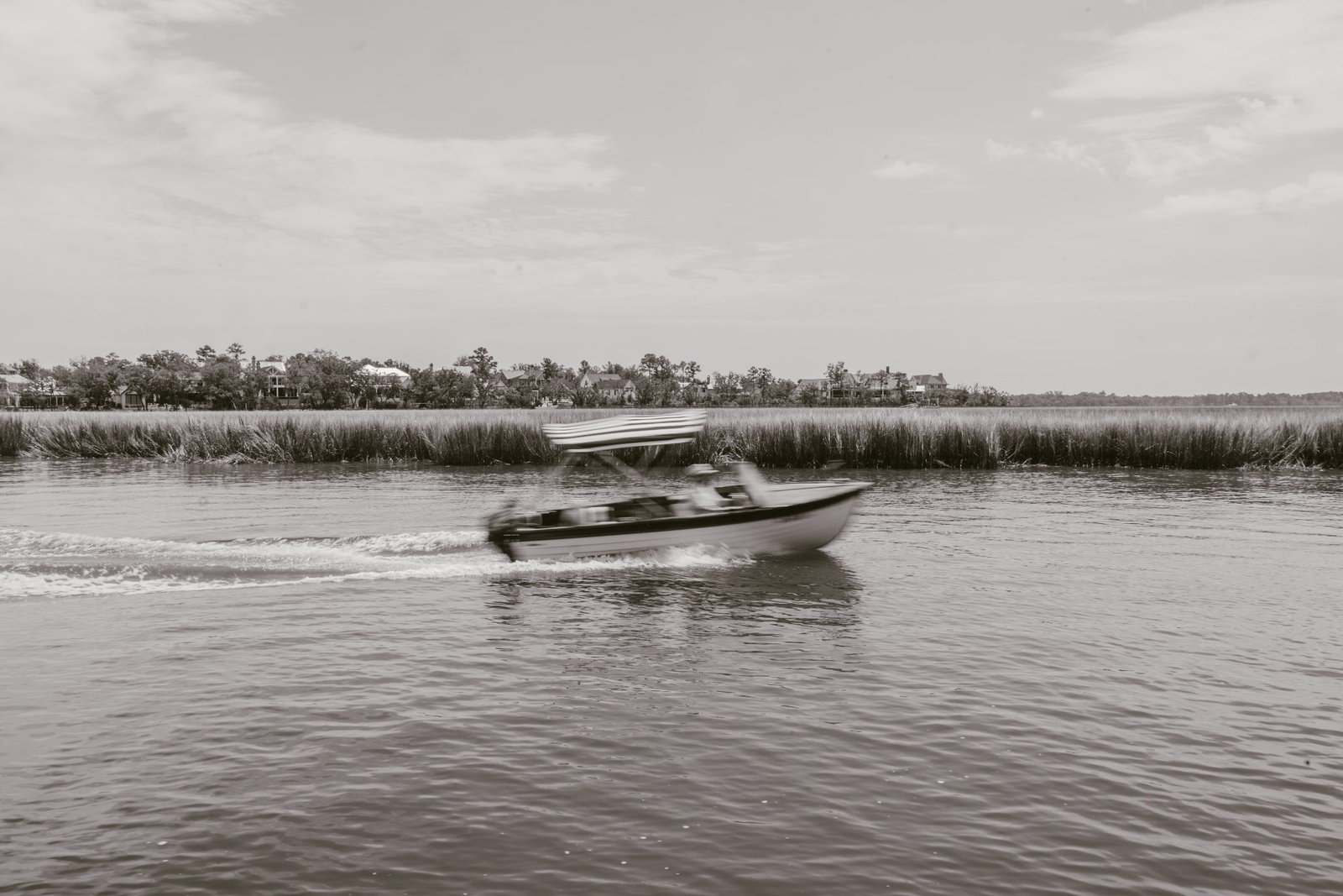 Old Saulty underway along the creek, striped bimini up