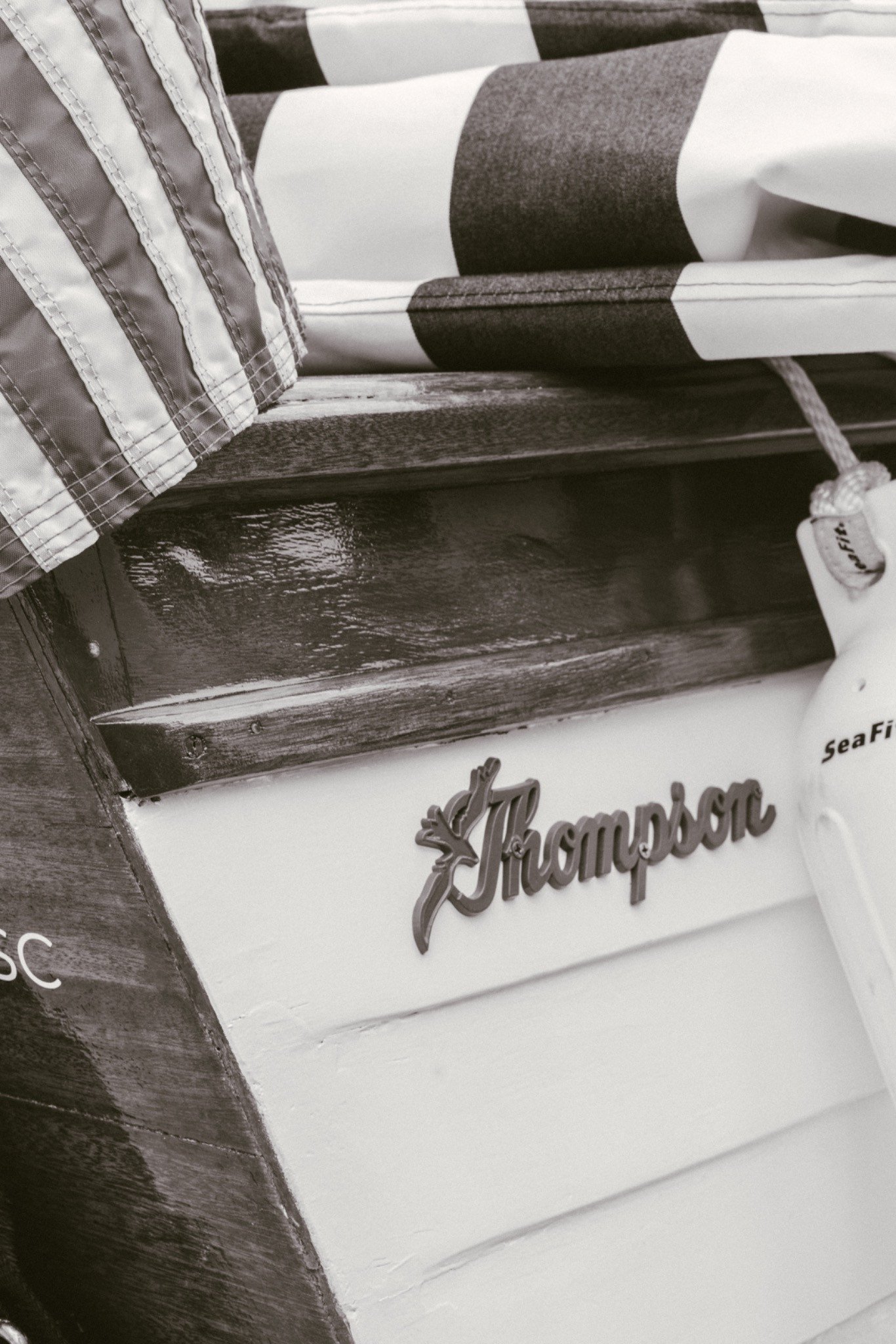 The original Thompson script badge on the white lapstrake hull