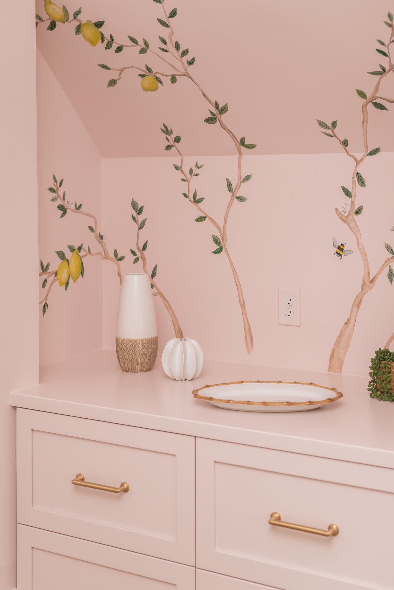 Blush built-in drawers styled with bamboo-edge platter and vases
